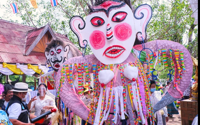 A close-up of the Phi Ta Khon Yai mask, towering in size and adorned with intricate hand-painted details