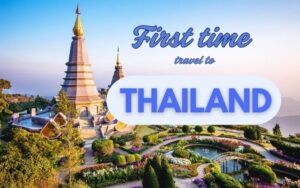 Travel to Thailand for the First Time: A stunning view of twin pagodas at Doi Inthanon in Chiang Mai, surrounded by colorful gardens under a bright blue sky, with the text “First time travel to Thailand” overlaid.
