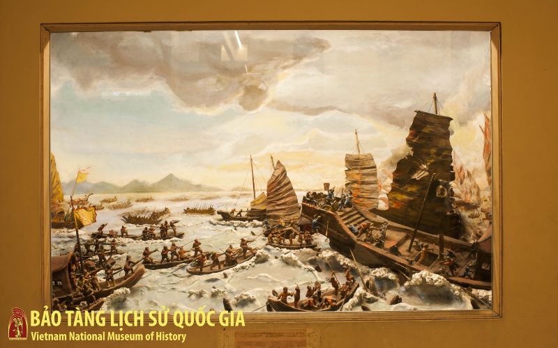 A large museum display featuring a diorama or painting depicting the historic naval Battle of Bach Dang River in 938.