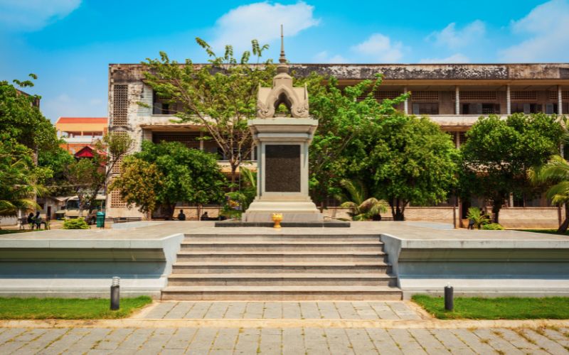Tuol Sleng Genocide Museum building in Phnom Penh with courtyard and memorial monument.