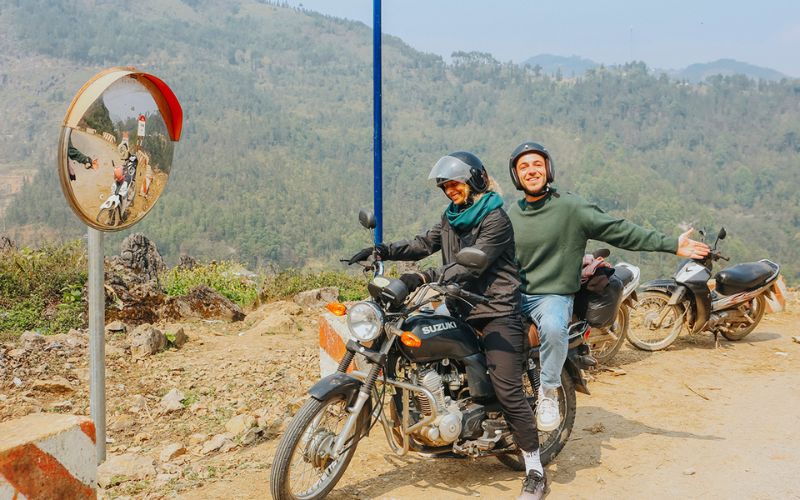 Visitors exploring the Ha Giang Loop by motorbike, enjoying adventure travel and mountainous scenery in northern Vietnam