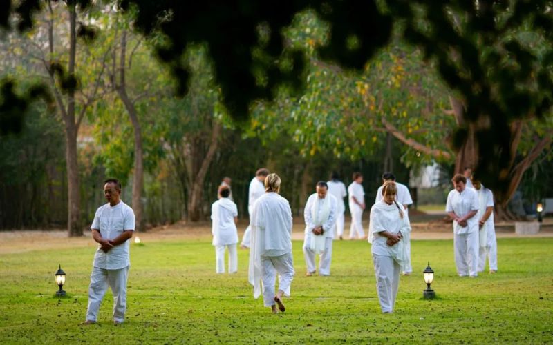 People practicing walking meditation outdoors in Techno mediation retreat - Song Khon, Kaeng Khoi District, Saraburi Province - Thailand