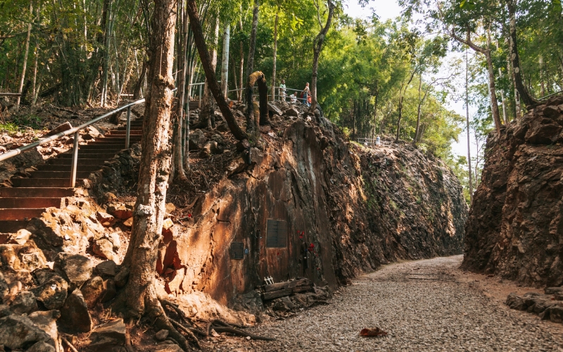 The preserved railway cutting at Hellfire Pass, surrounded by dense jungle, where prisoners of war once worked under harsh conditions.