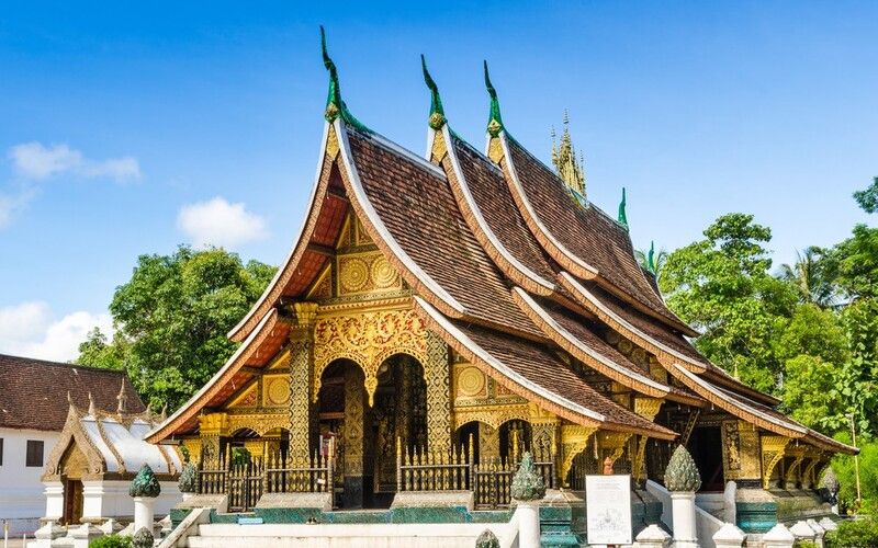 Wat Xieng Thong, a stunning Buddhist temple in Luang Prabang, Laos, showcasing traditional Lao architecture with ornate golden decorations and sweeping rooflines.