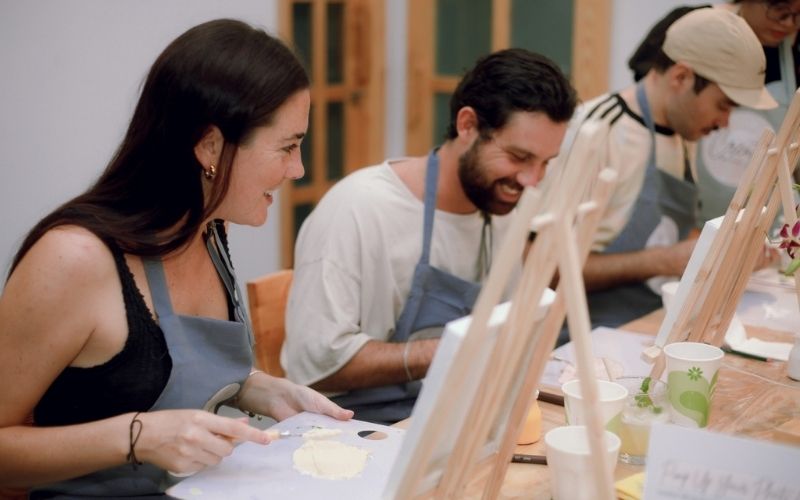 Tourists enjoying a hands-on painting workshop in Da Nang, Vietnam – a creative cultural experience for international visitors